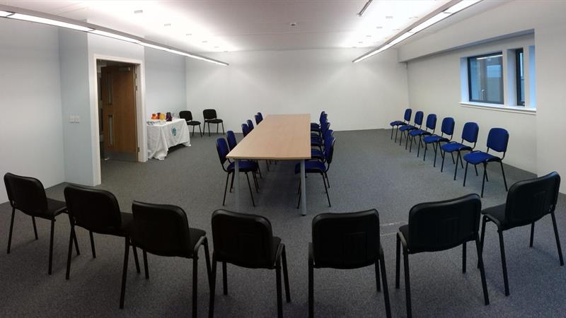 Large office converted into Conference area fitting over 30 people and a table.